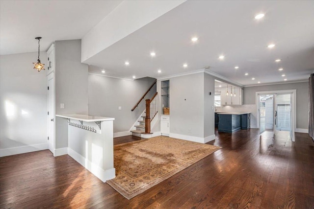 entrance foyer with dark hardwood / wood-style flooring and ornamental molding