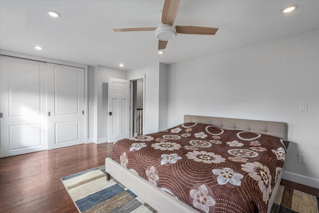 bedroom with a closet, dark hardwood / wood-style floors, and ceiling fan