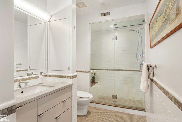 bathroom featuring tile walls, tile patterned floors, and walk in shower