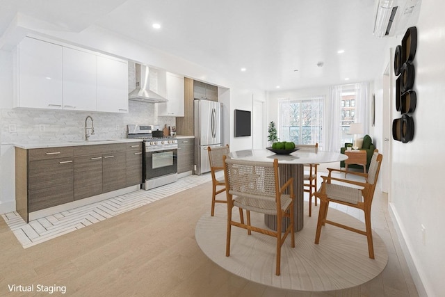 dining space with baseboards, recessed lighting, and light wood-type flooring