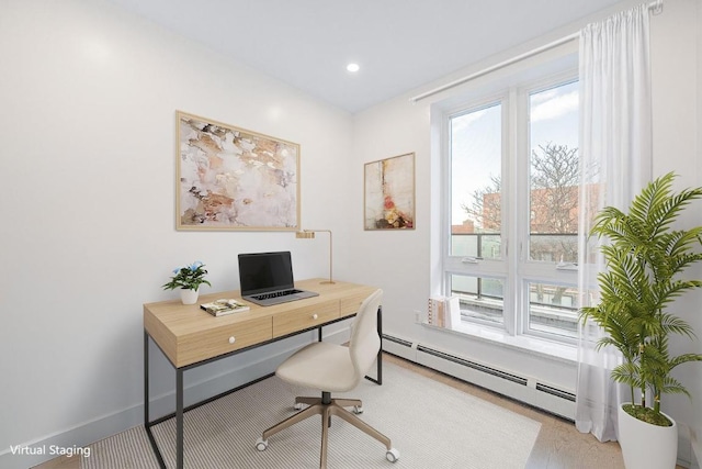 office space with a baseboard heating unit and hardwood / wood-style flooring