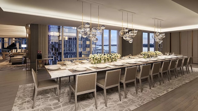 dining space featuring a water view and hardwood / wood-style flooring