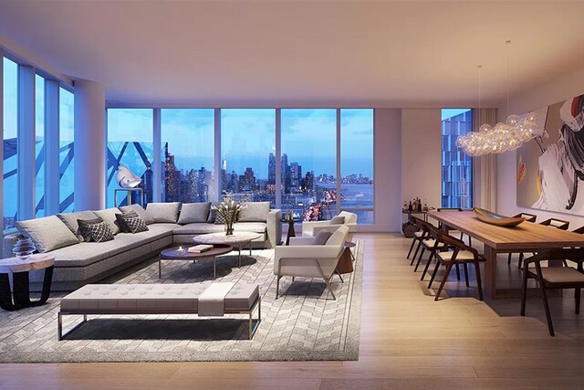 30 Riverside Blvd Unit 20-K, New York City, NY 10069 - living room with light wood finished floors, a wall of windows, a city view, and an inviting chandelier