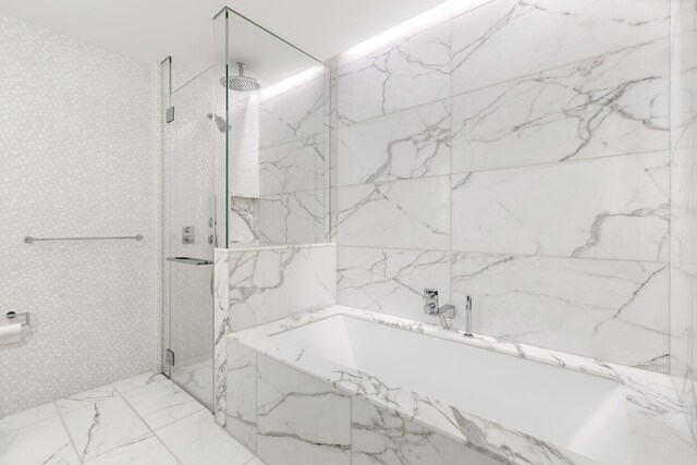 30 Riverside Blvd Unit 20-K, New York City, NY 10069 - full bath featuring stone wall, a bath, and a marble finish shower