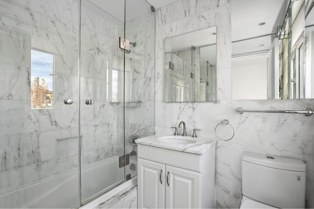 full bathroom featuring vanity, toilet, and combined bath / shower with glass door