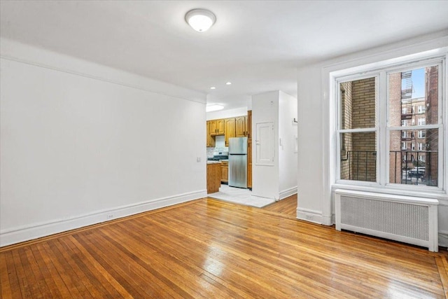 interior space featuring radiator and light hardwood / wood-style floors