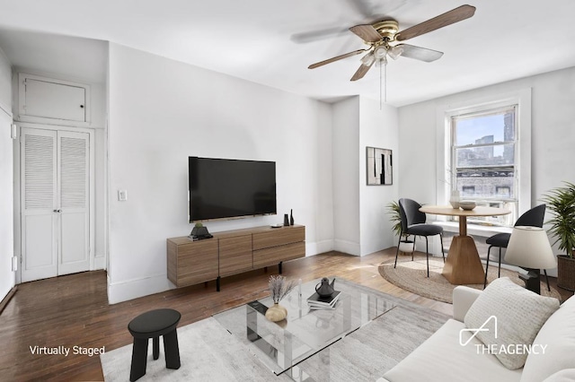 living room featuring hardwood / wood-style flooring and ceiling fan