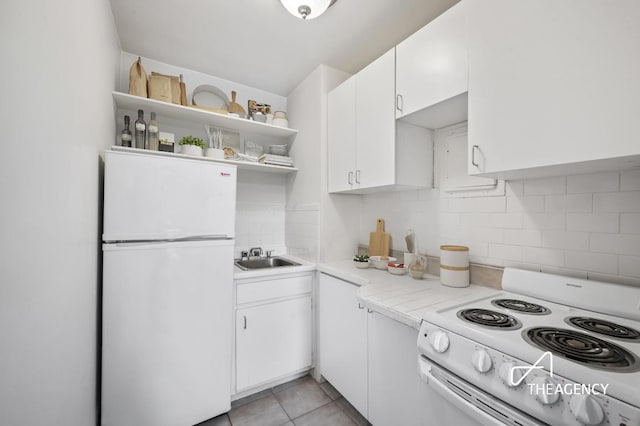 kitchen with light tile patterned flooring, white cabinetry, sink, decorative backsplash, and white appliances