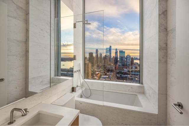 bathroom with a relaxing tiled tub and vanity