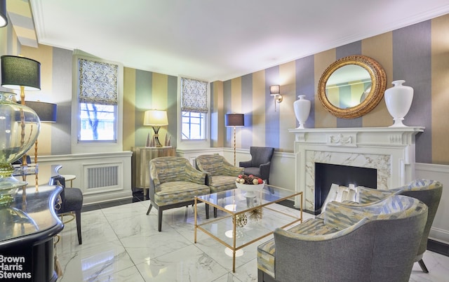 sitting room featuring ornamental molding and a premium fireplace