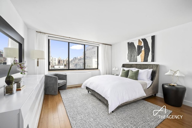 bedroom with hardwood / wood-style floors