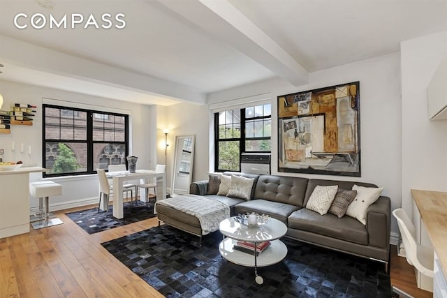 living room with beamed ceiling and hardwood / wood-style floors