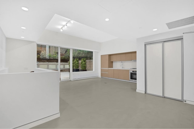 459 W 18th St Unit 1, New York City, NY 10011 - unfurnished living room with finished concrete floors, recessed lighting, and track lighting