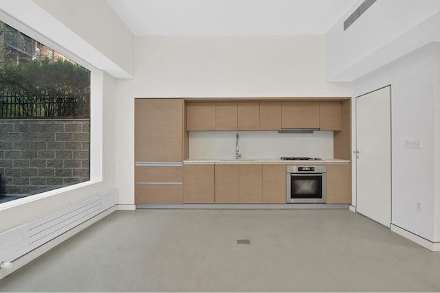 459 W 18th St Unit 1, New York City, NY 10011 - kitchen with oven, concrete floors, light countertops, and under cabinet range hood