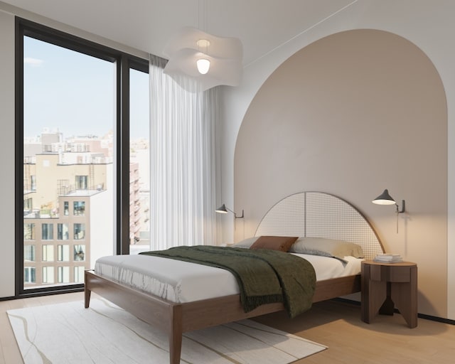 bedroom with expansive windows and light hardwood / wood-style flooring