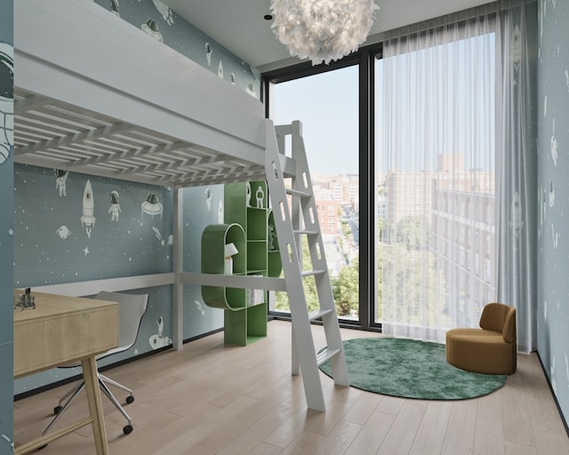 bedroom featuring expansive windows, hardwood / wood-style floors, and a chandelier