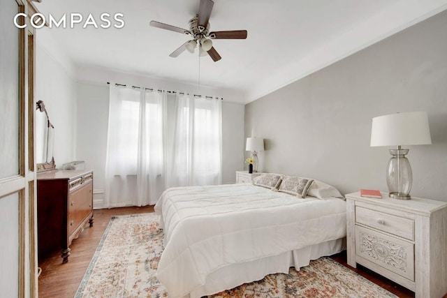 bedroom with light hardwood / wood-style floors and ceiling fan