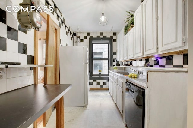 kitchen featuring sink, hanging light fixtures, white refrigerator, dishwasher, and white cabinets