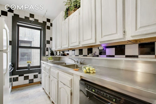 kitchen with white refrigerator, dishwasher, sink, and white cabinets