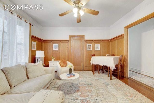 living room featuring ornamental molding, hardwood / wood-style floors, and ceiling fan