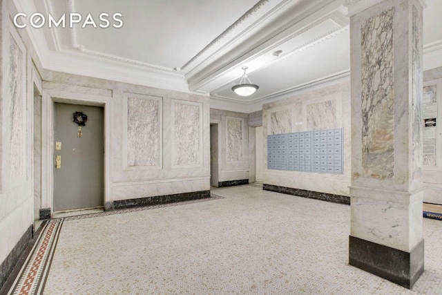 empty room featuring ornamental molding and a mail area