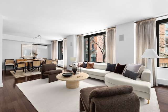 living area featuring dark wood-style floors, visible vents, and baseboards