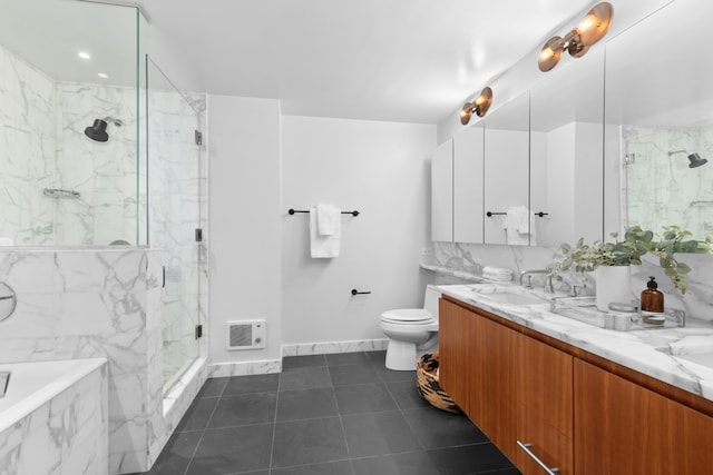 full bathroom featuring toilet, a sink, a marble finish shower, tile patterned floors, and double vanity