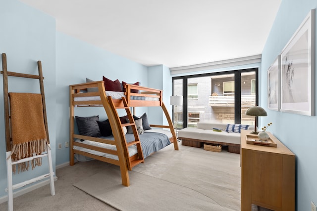 carpeted bedroom featuring baseboards