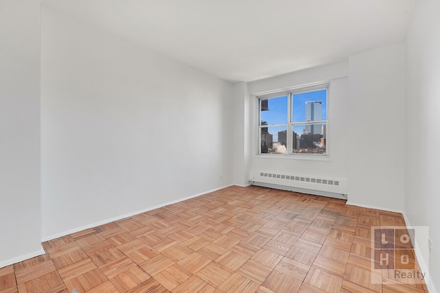 empty room with a baseboard radiator and baseboards