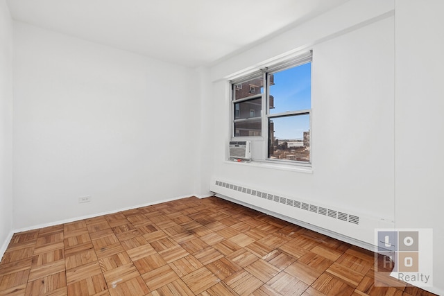 spare room with cooling unit, baseboards, and baseboard heating