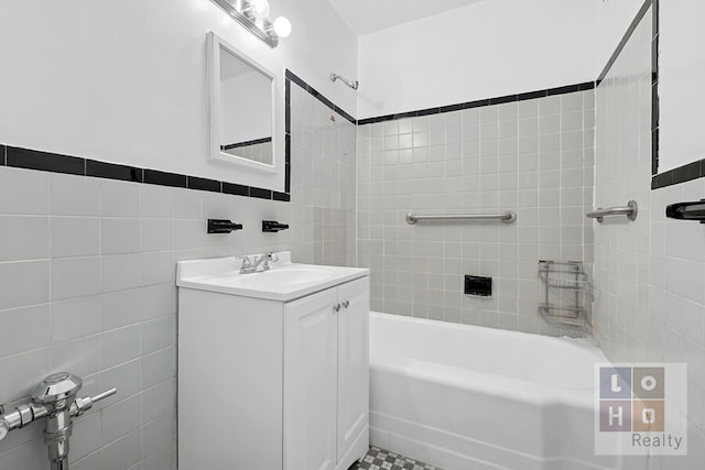 full bathroom with shower / bath combination, tile walls, and vanity