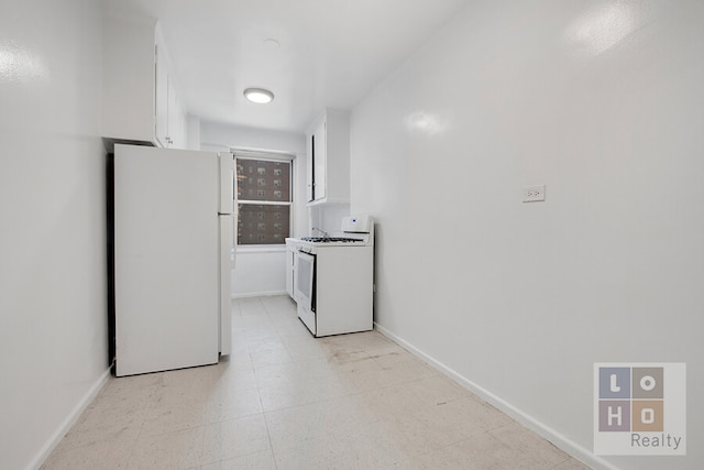 kitchen with white cabinets, white appliances, light floors, and baseboards