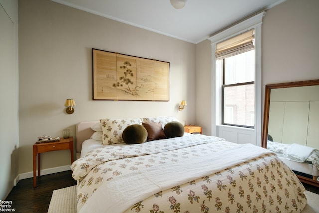 bedroom with ornamental molding, dark hardwood / wood-style floors, and a closet