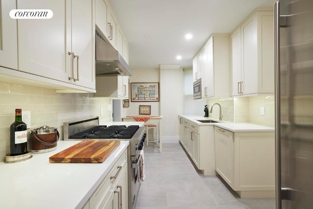 kitchen with appliances with stainless steel finishes, sink, and white cabinets