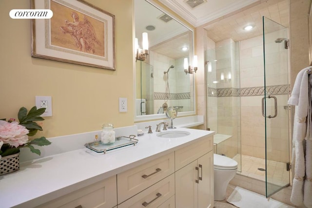 bathroom featuring vanity, crown molding, toilet, and walk in shower