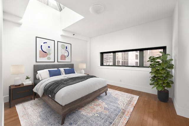 bedroom featuring baseboards and wood finished floors