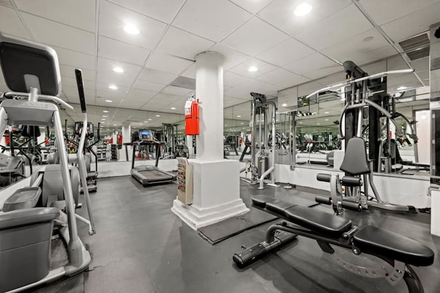 gym with a paneled ceiling