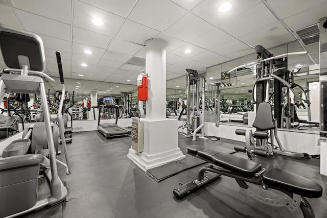 exercise room featuring a paneled ceiling and recessed lighting