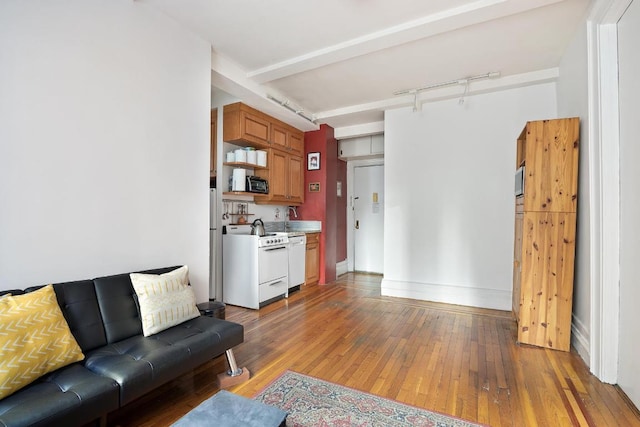 living room with beam ceiling, track lighting, and light wood-type flooring