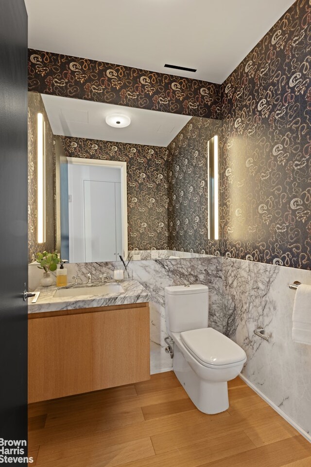 bathroom with a tub, tile walls, and toilet