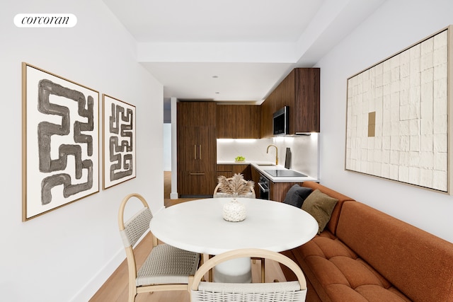 dining area with visible vents, baseboards, and light wood-style flooring