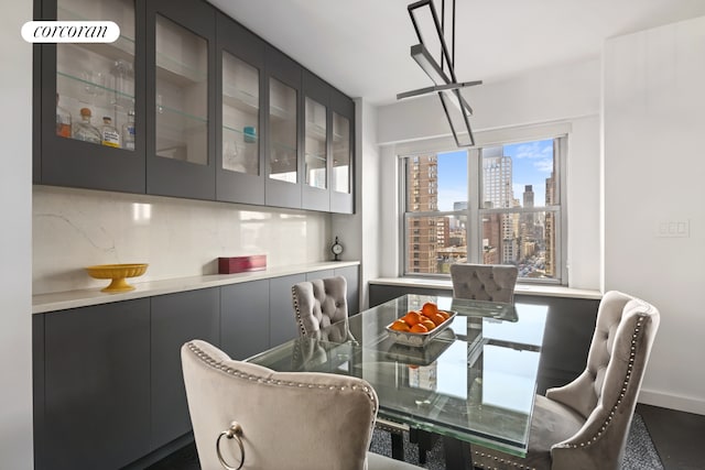 dining space featuring a view of city and baseboards