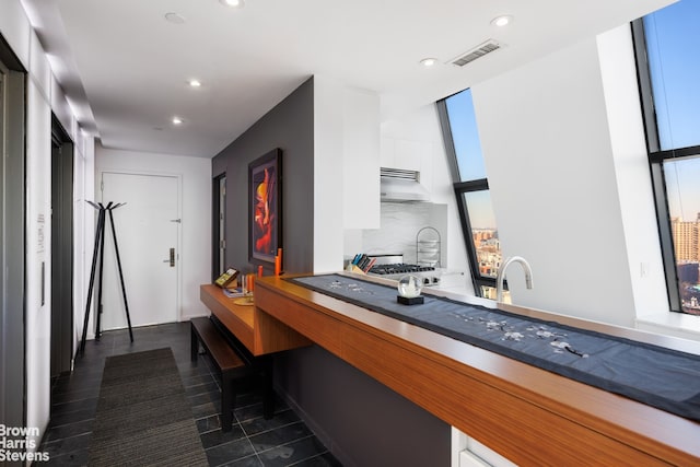 kitchen with white cabinetry and decorative backsplash