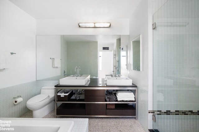 bathroom featuring vanity, tile walls, an enclosed shower, and toilet