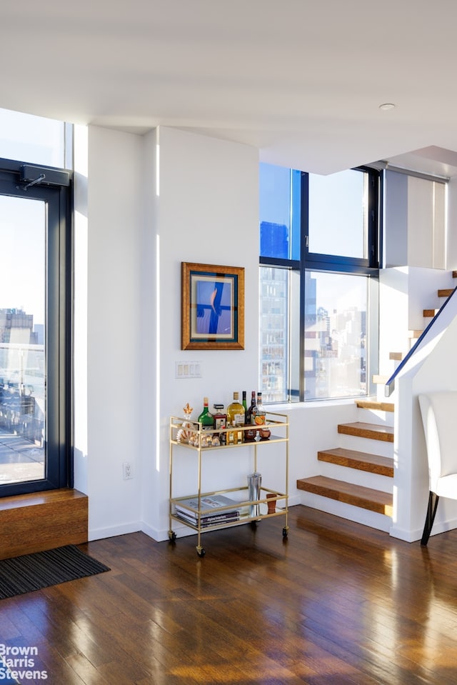 staircase with hardwood / wood-style floors and baseboards