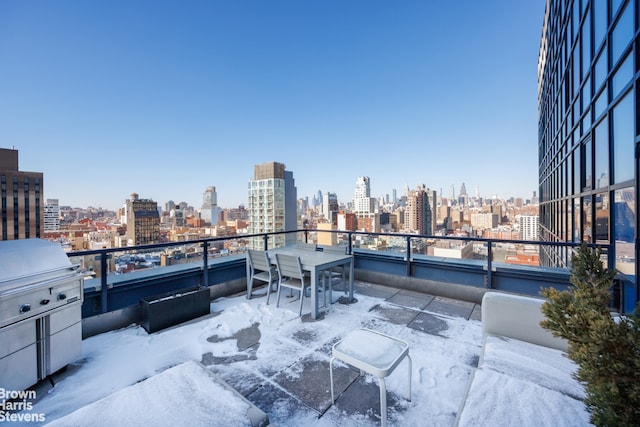 snow covered patio with a balcony