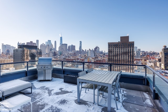 balcony featuring a city view and a grill