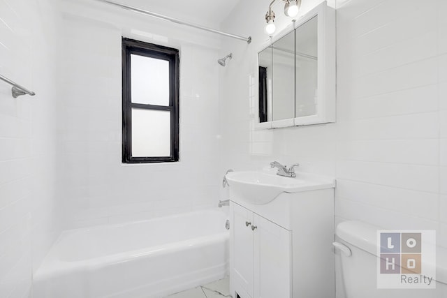 bathroom with toilet, marble finish floor, shower / bath combination, and vanity