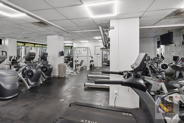 exercise room featuring a drop ceiling