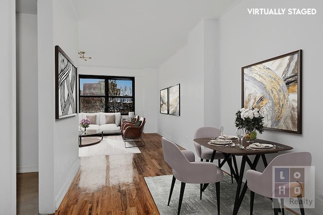 dining space with wood finished floors and baseboards